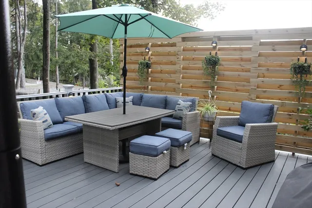 a view of a patio with couches and umbrella