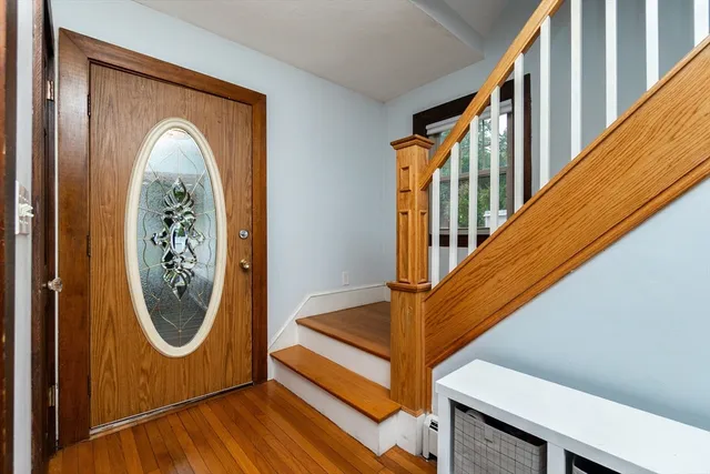 a view of a entryway with wooden floor and window