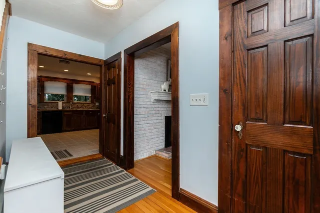 a view of kitchen with kitchen island wooden floor and refrigerator