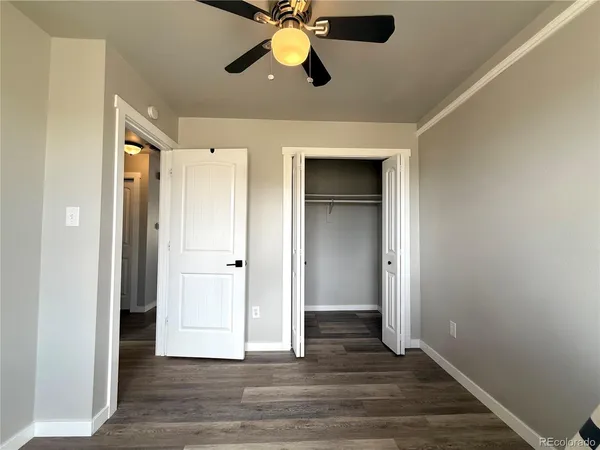 a view of an empty room and wooden floor