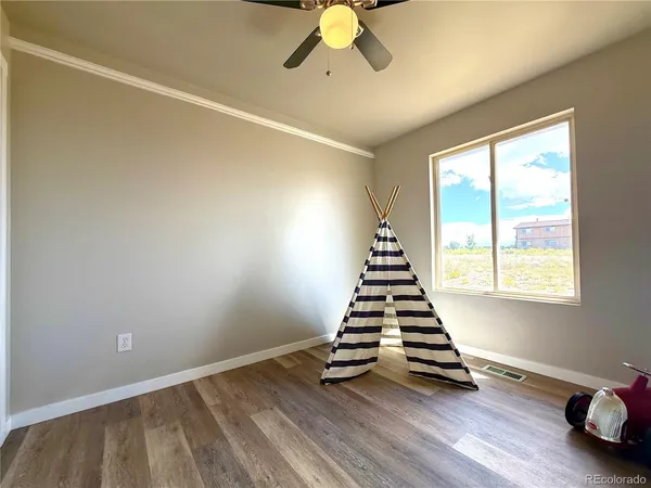 a view of a livingroom with wooden floor and a window