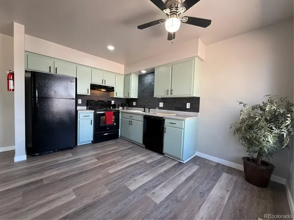 a kitchen with stainless steel appliances kitchen island a refrigerator sink and stove