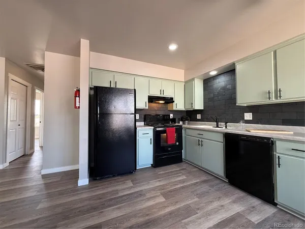 a kitchen with a refrigerator and a sink
