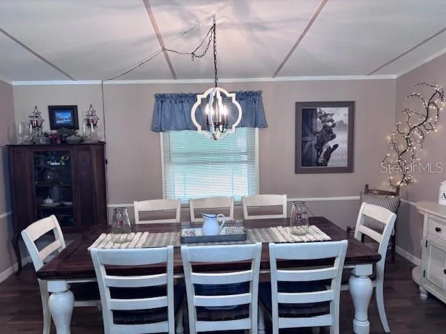 a dining room with furniture a rug and wooden floor