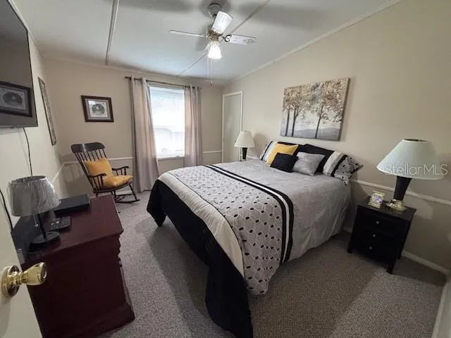 a bedroom with a bed wooden floor and lamp