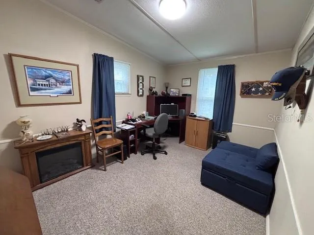 a living room with furniture and a mirror