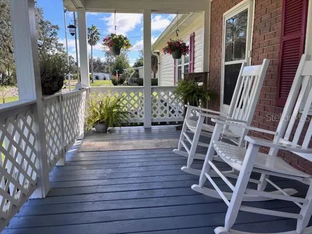a porch with seating space and wooden floor