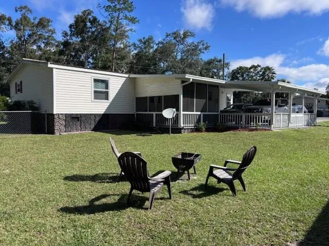 a view of a backyard with furniture