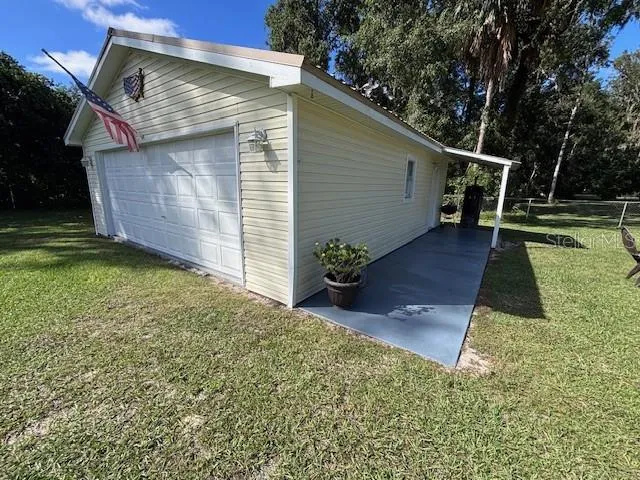 a backyard of a house with plants and wooden fence