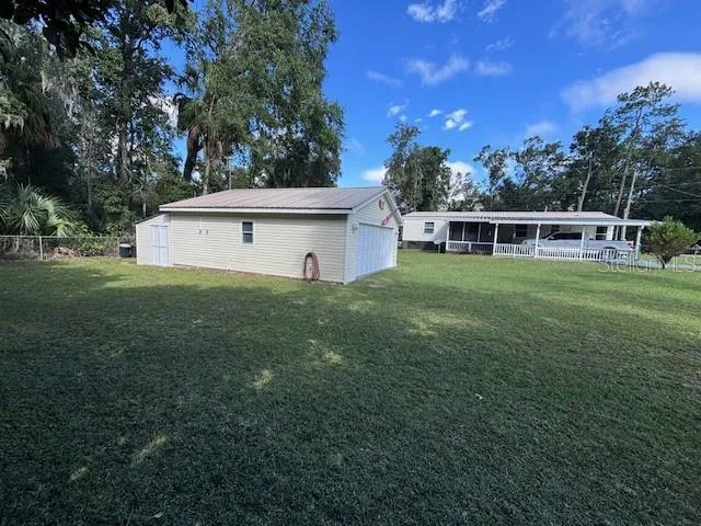 a view of a house with yard and sitting area