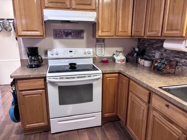 a kitchen with cabinets appliances and a counter space