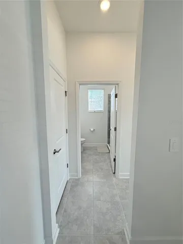 a view of a hallway with wooden shelves