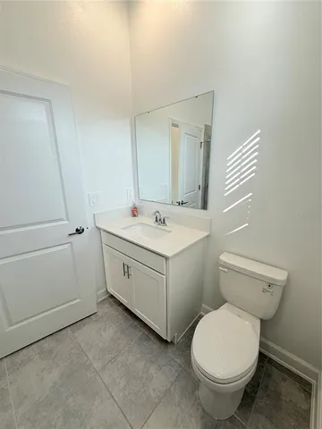 a utility room with a sink and a toilet