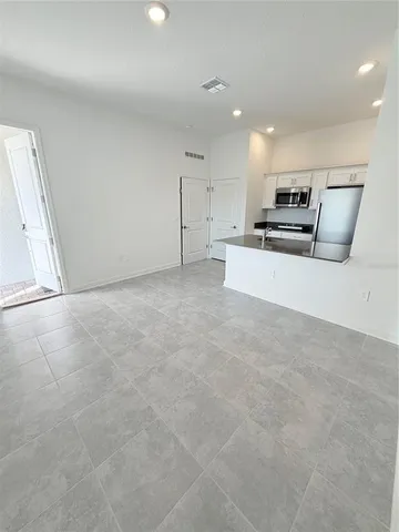 a view of kitchen with kitchen island microwave and stove