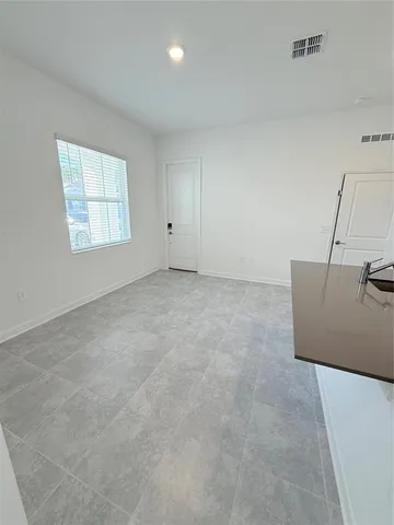 a view of an empty room and a window