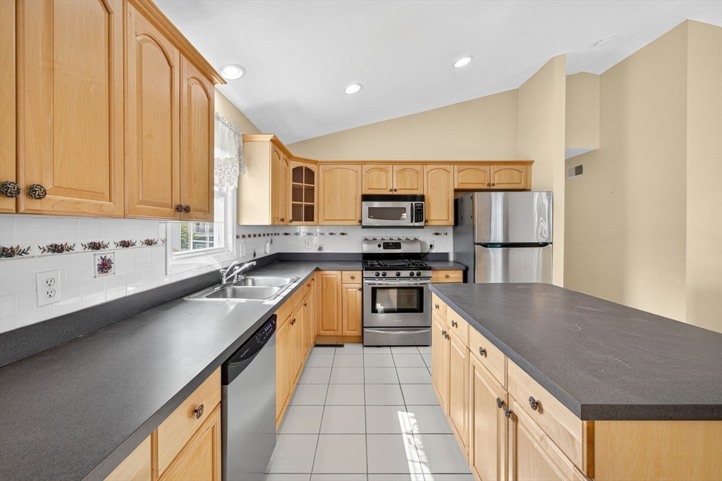 172 Stevens Street Fall River, MA 02721 - Photo 12 of 32 a kitchen with stainless steel appliances a sink dishwasher stove refrigerator and microwave