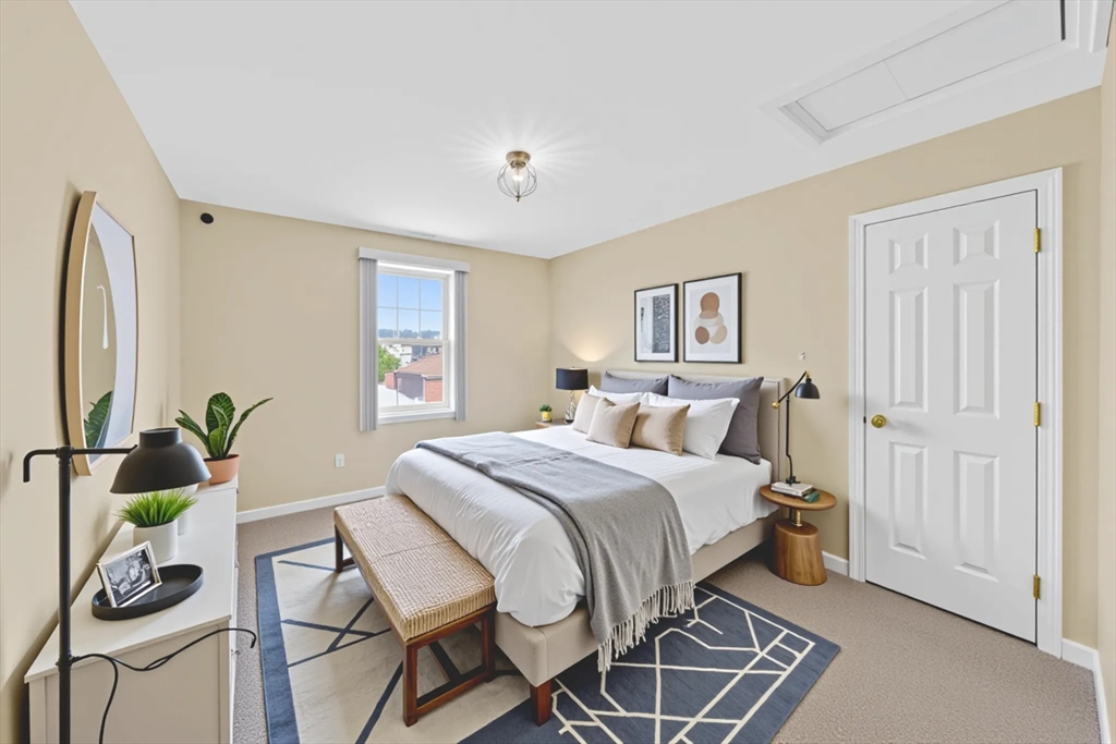 172 Stevens Street Fall River, MA 02721 - Photo 17 of 32 a bed room with a bed and a chair