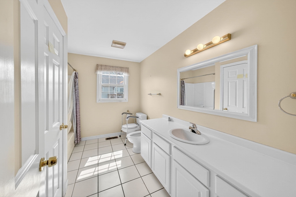 172 Stevens Street Fall River, MA 02721 - Photo 18 of 32 a spacious bathroom with a double vanity sink a mirror and a shower