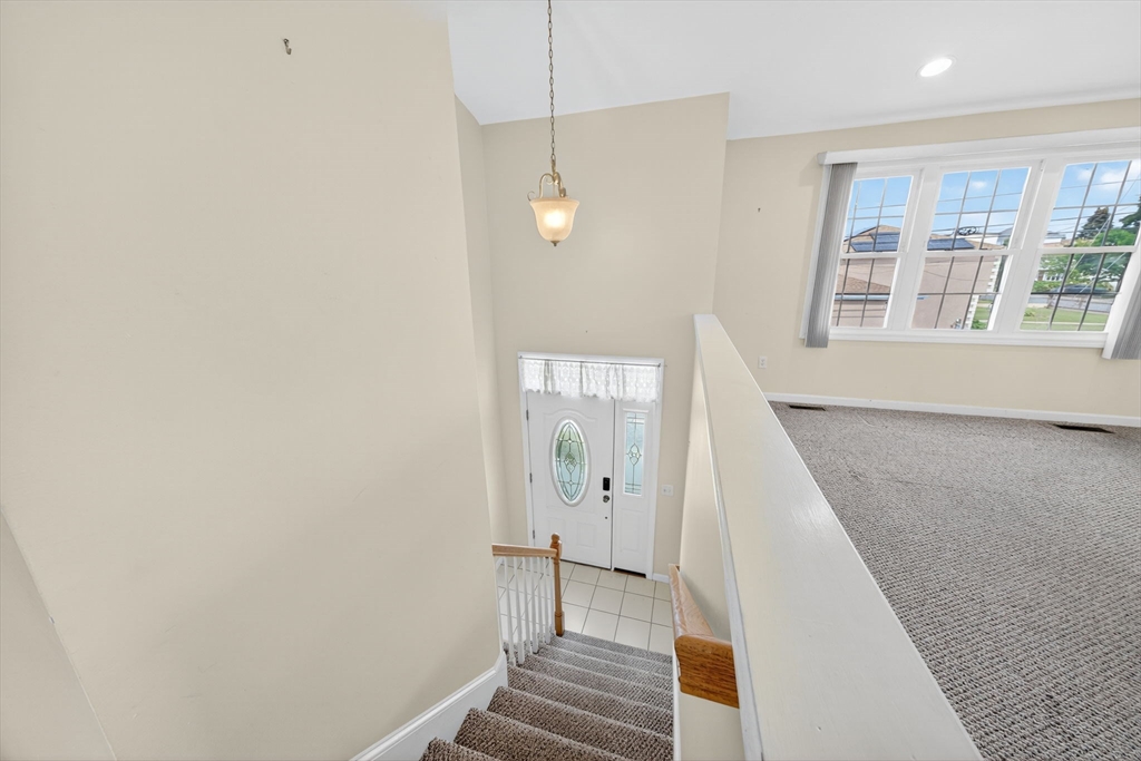 172 Stevens Street Fall River, MA 02721 - Photo 7 of 32 a view of a hallway with wooden floor and staircase