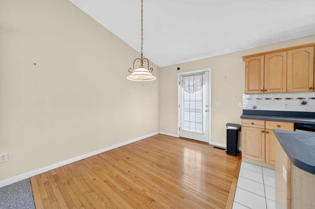 172 Stevens Street Fall River, MA 02721 - Photo 10 of 32 a view of a kitchen with wooden floor and a window