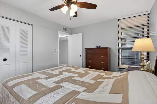 a bedroom with a bed and a dresser