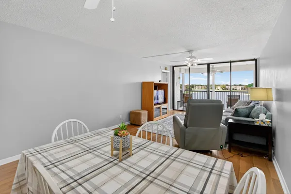 a living room with furniture a flat screen tv and a large window