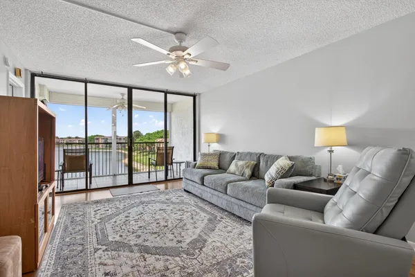 a living room with furniture and a floor to ceiling window