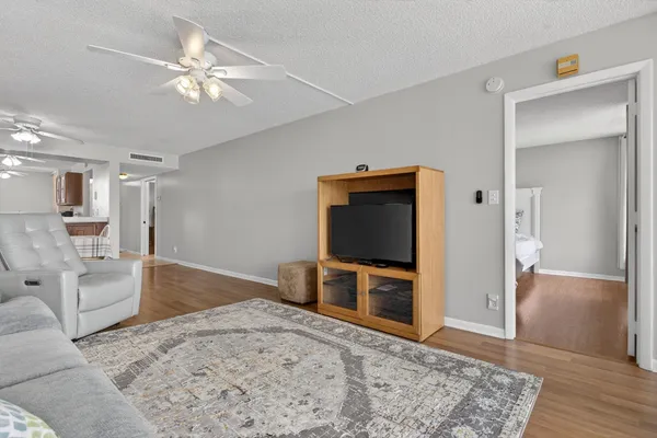 a bedroom with furniture and a flat screen tv