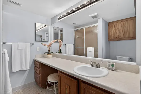 a bathroom with a granite countertop sink a mirror and a
