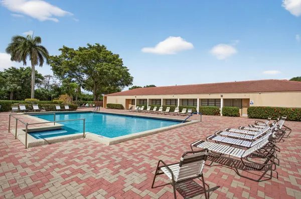 swimming pool view with a seating space