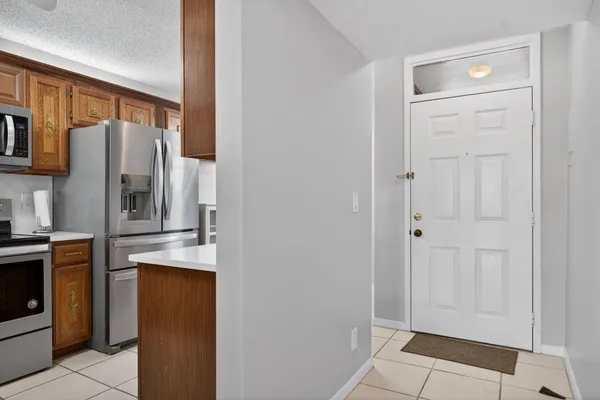 a kitchen with stainless steel appliances granite countertop a refrigerator and a stove top oven