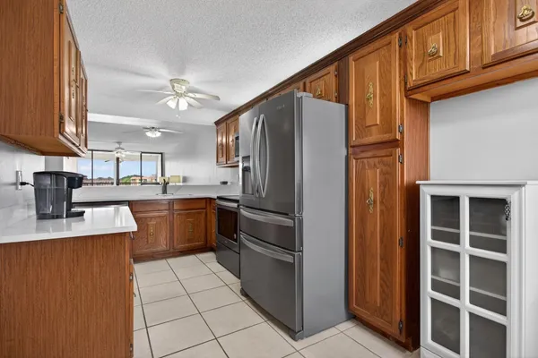 a kitchen with stainless steel appliances granite countertop a refrigerator and a stove top oven