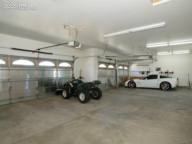 12153 Rio Secco Road Peyton, CO 80831 - Photo 8 of 26 Plenty of room for all of your vehicles and/or toys! Garage is oversized, insulated, heated & wired for 220v.