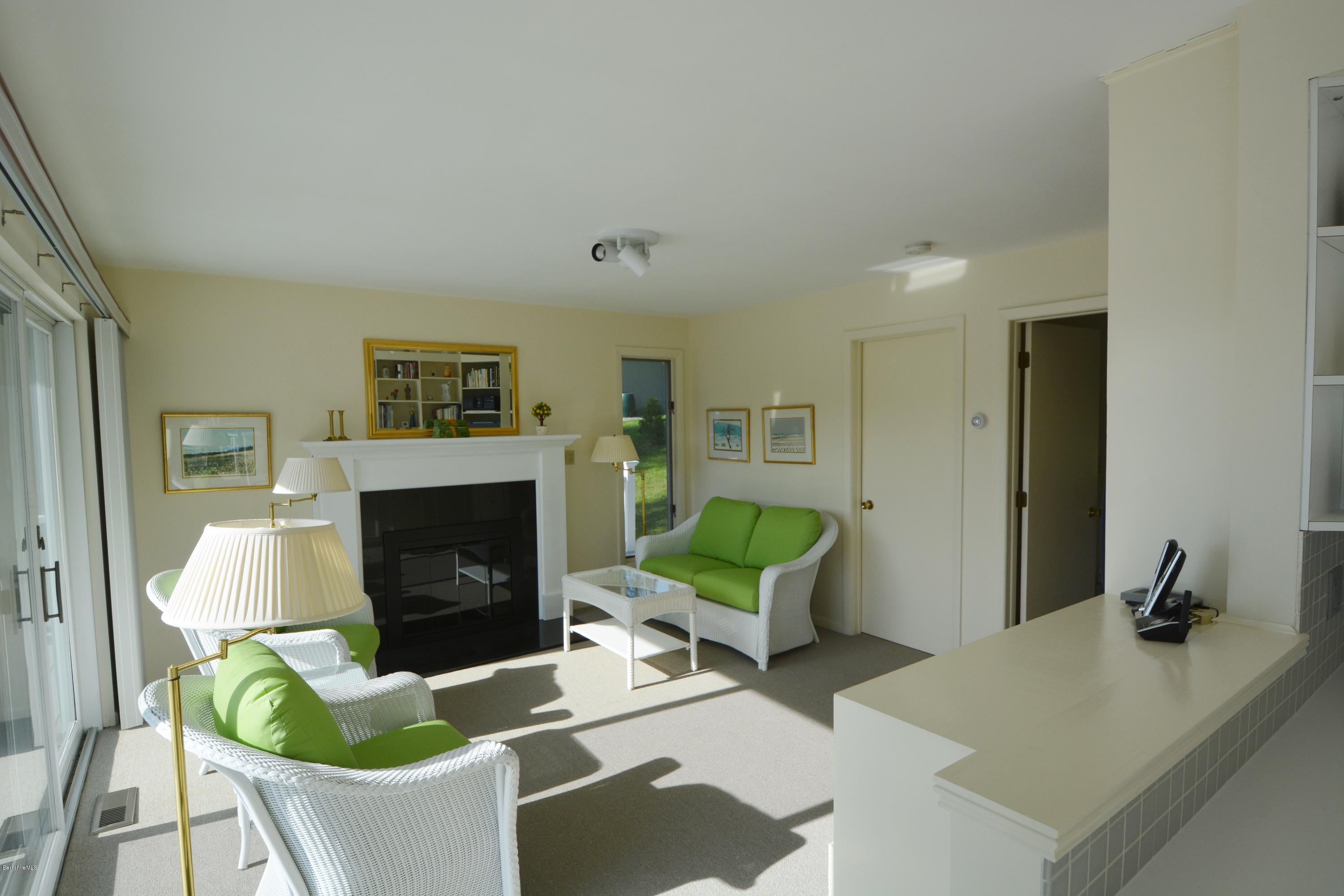 633 Pine Road Otis, MA 01029 - Photo 11 of 24 a living room with furniture a fireplace and a flat screen tv