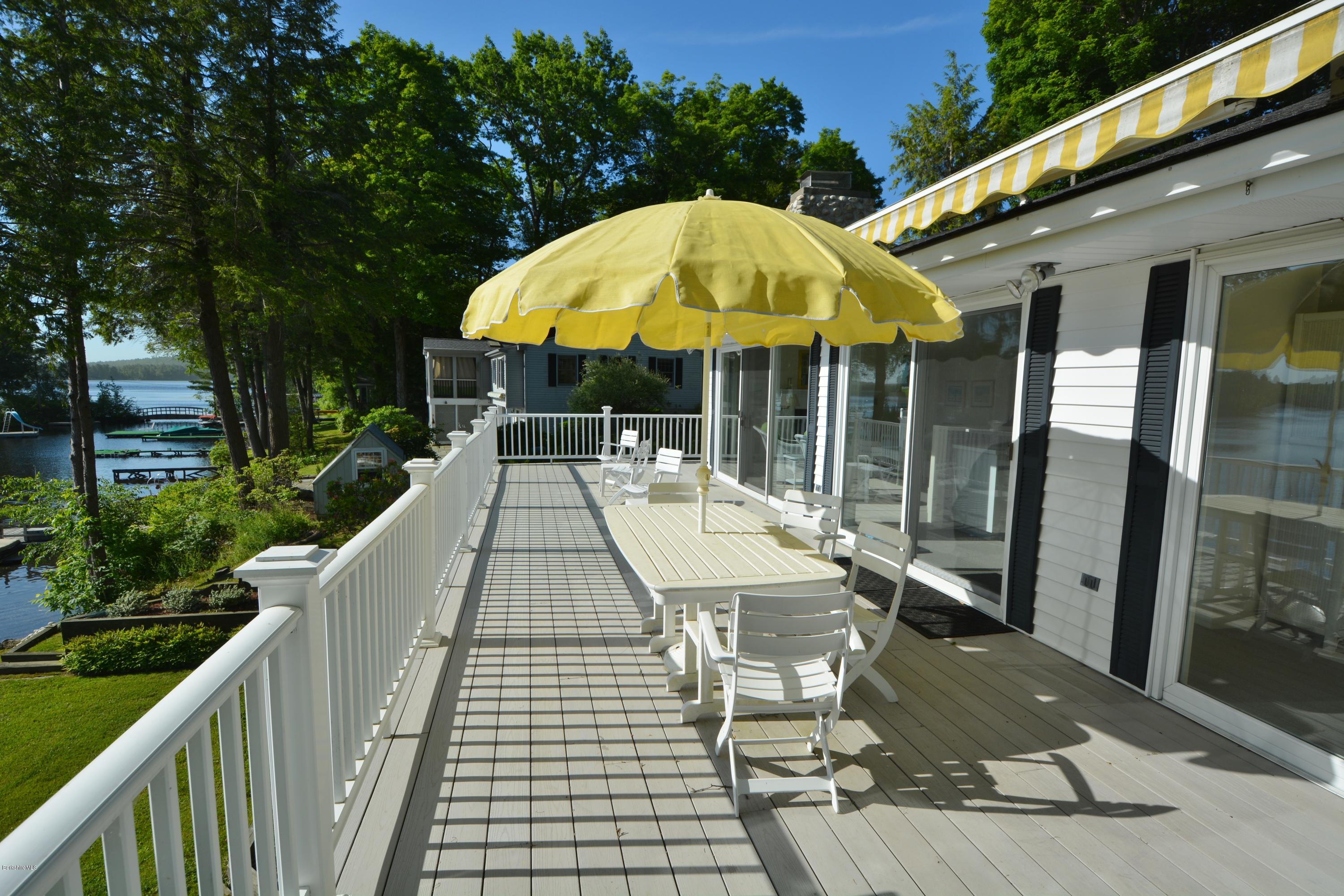 633 Pine Road Otis, MA 01029 - Photo 17 of 24 a view of a patio with a table and chairs under an umbrella