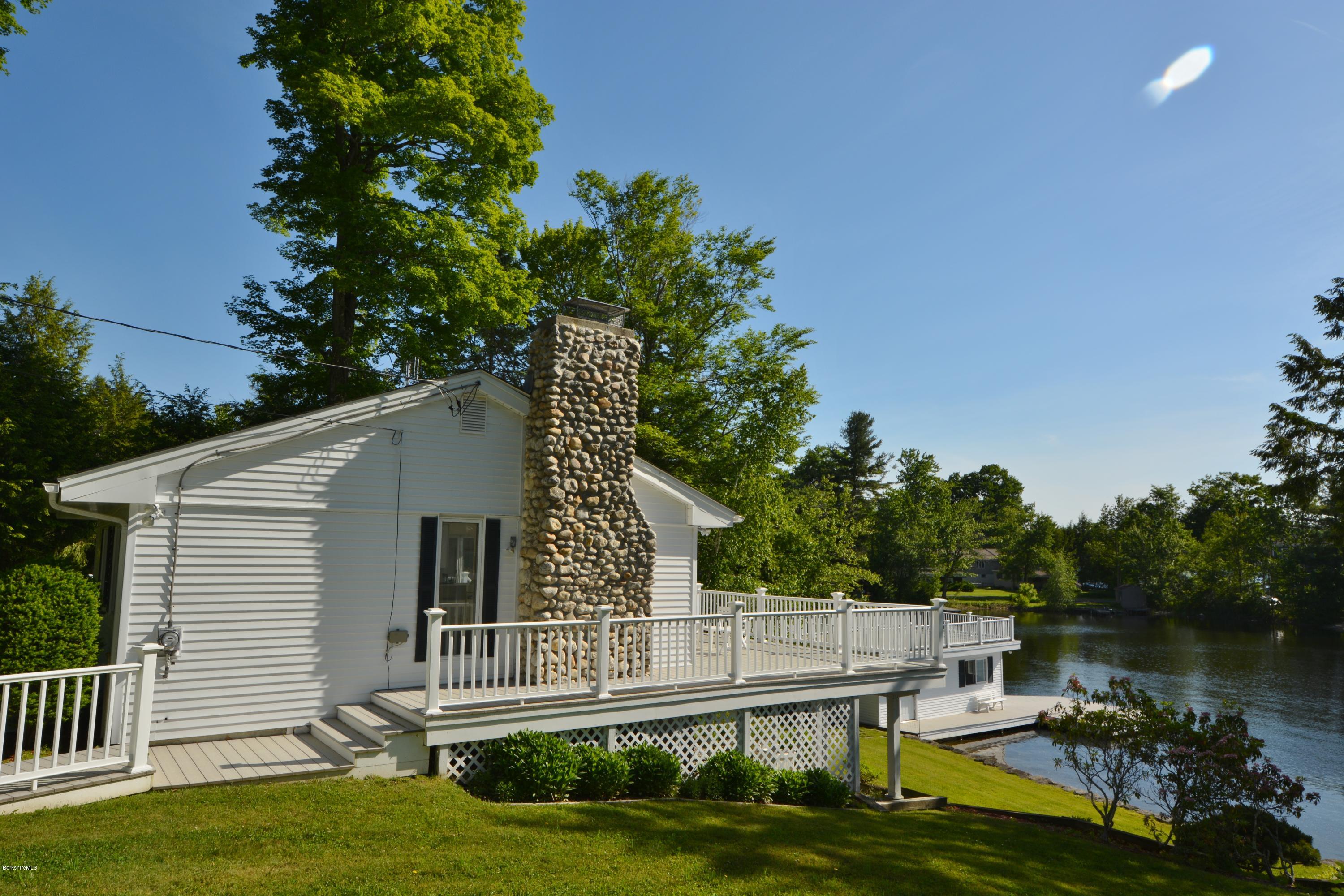 633 Pine Road Otis, MA 01029 - Photo 22 of 24 a view of a white house with a yard