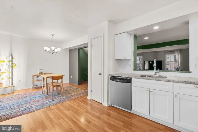a kitchen with kitchen island a sink stainless steel appliances and dining table