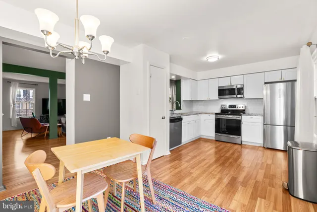 a kitchen with kitchen island a sink counter space and stainless steel appliances