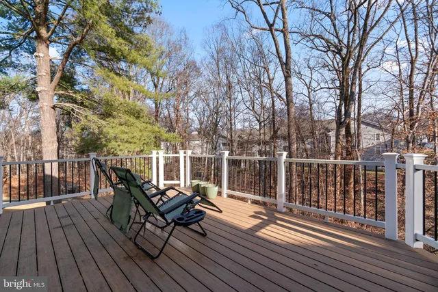 a view of balcony with wooden floor and fence