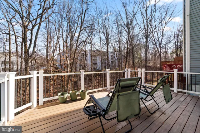 a view of a deck with furniture and wooden floor