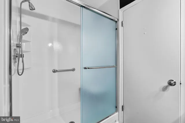 a bathroom with a glass shower door