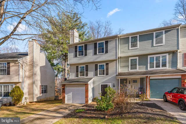 a front view of a house with garden and plants