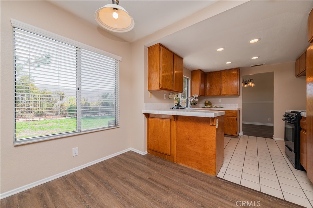 13090 Red Corral Drive Corona, CA 92883 - Photo 12 of 39 a kitchen with stainless steel appliances granite countertop a refrigerator a sink dishwasher and a stove with wooden floor