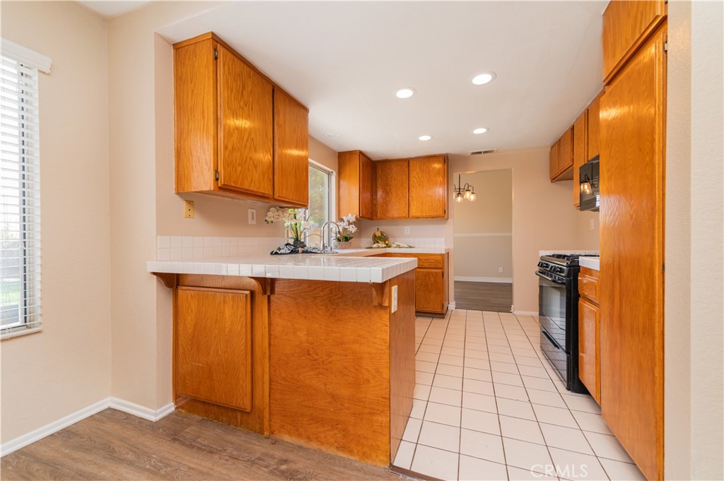 13090 Red Corral Drive Corona, CA 92883 - Photo 13 of 39 a kitchen with stainless steel appliances granite countertop a refrigerator and a stove top oven