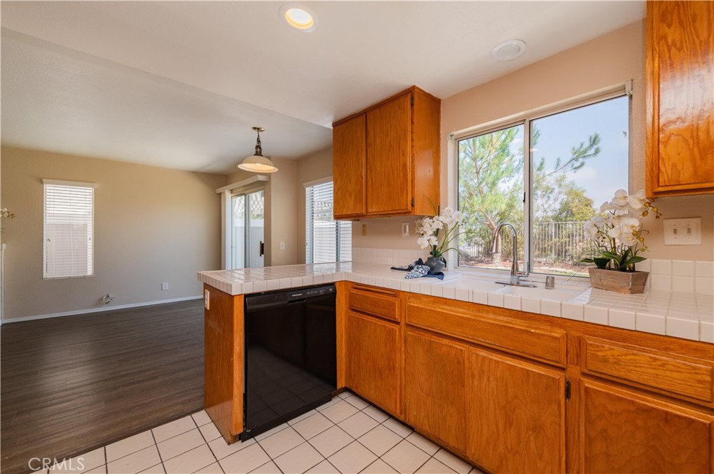 13090 Red Corral Drive Corona, CA 92883 - Photo 15 of 39 a kitchen with stainless steel appliances granite countertop a sink a stove and cabinets
