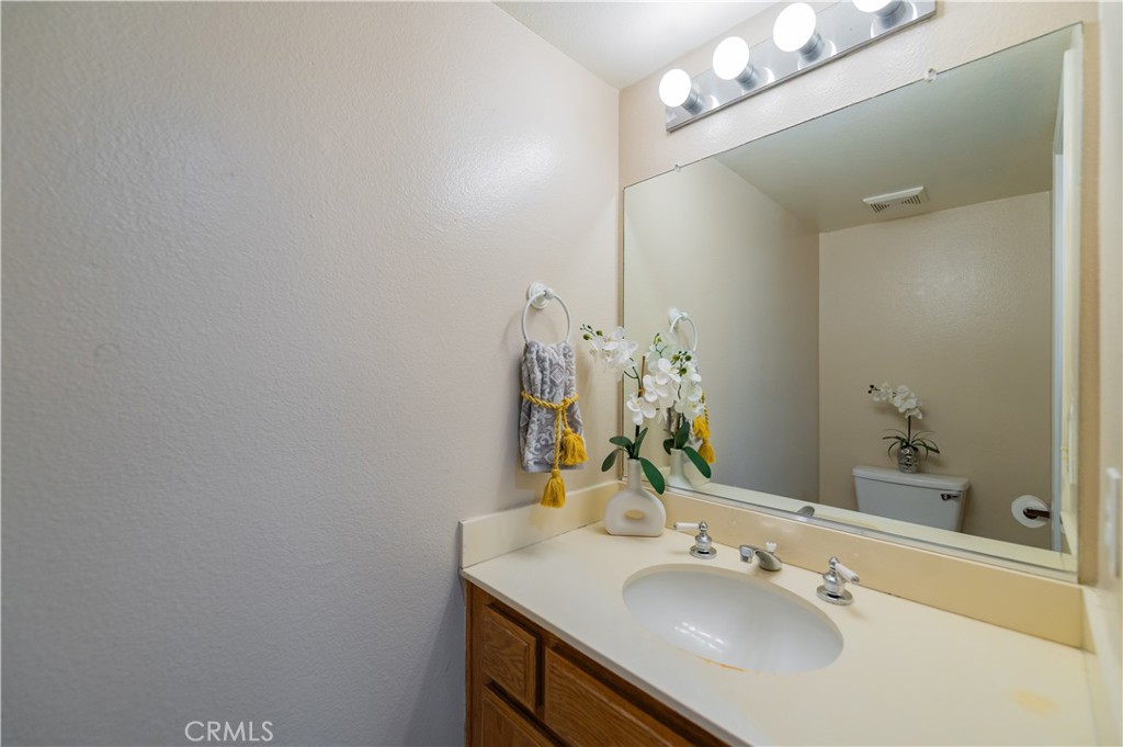 13090 Red Corral Drive Corona, CA 92883 - Photo 18 of 39 a bathroom with a sink vanity and a mirror