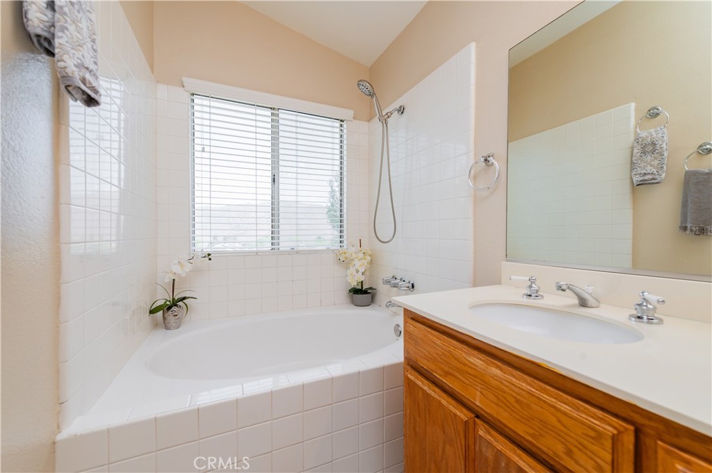 13090 Red Corral Drive Corona, CA 92883 - Photo 25 of 39 a bathroom with a tub sink and mirror