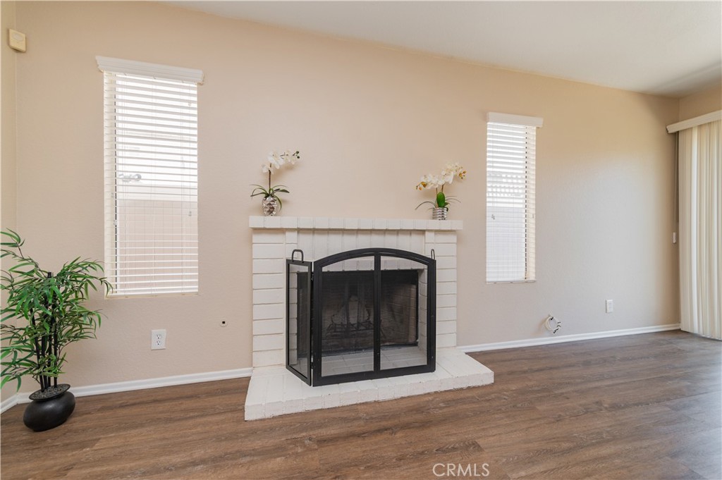 13090 Red Corral Drive Corona, CA 92883 - Photo 10 of 39 a living room with a fireplace and wooden floor