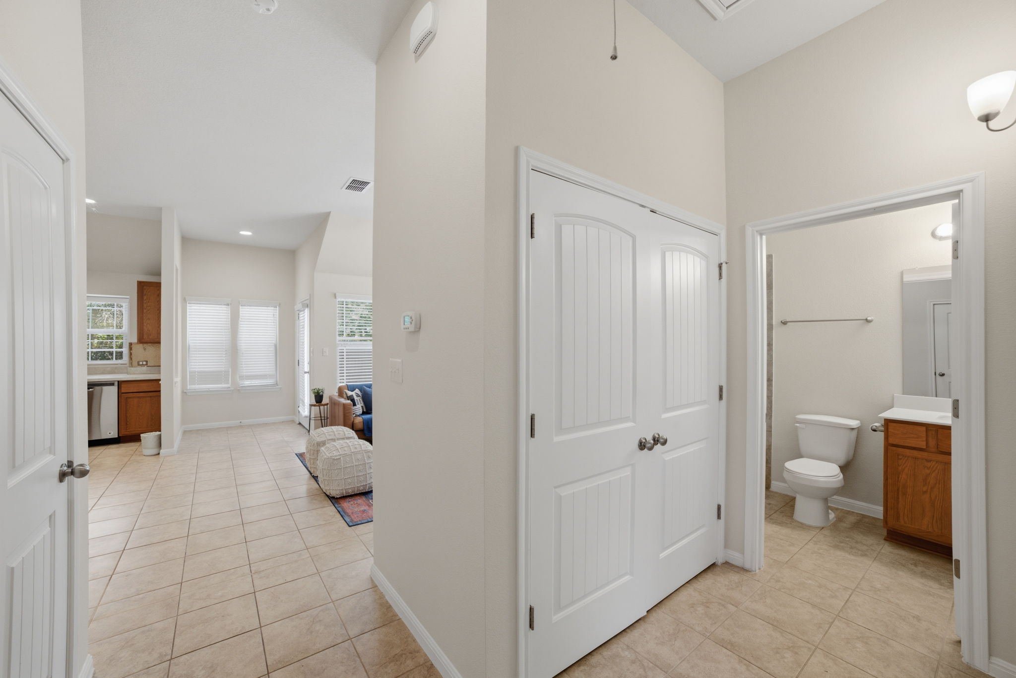 514 Nautical Loop Kyle, TX 78640 - Photo 19 of 24 Clean lines and tiled floors lead to a sunlit living space and an adjacent full bathroom.
