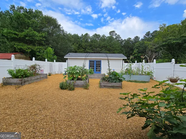 a view of a house with pool and sitting area